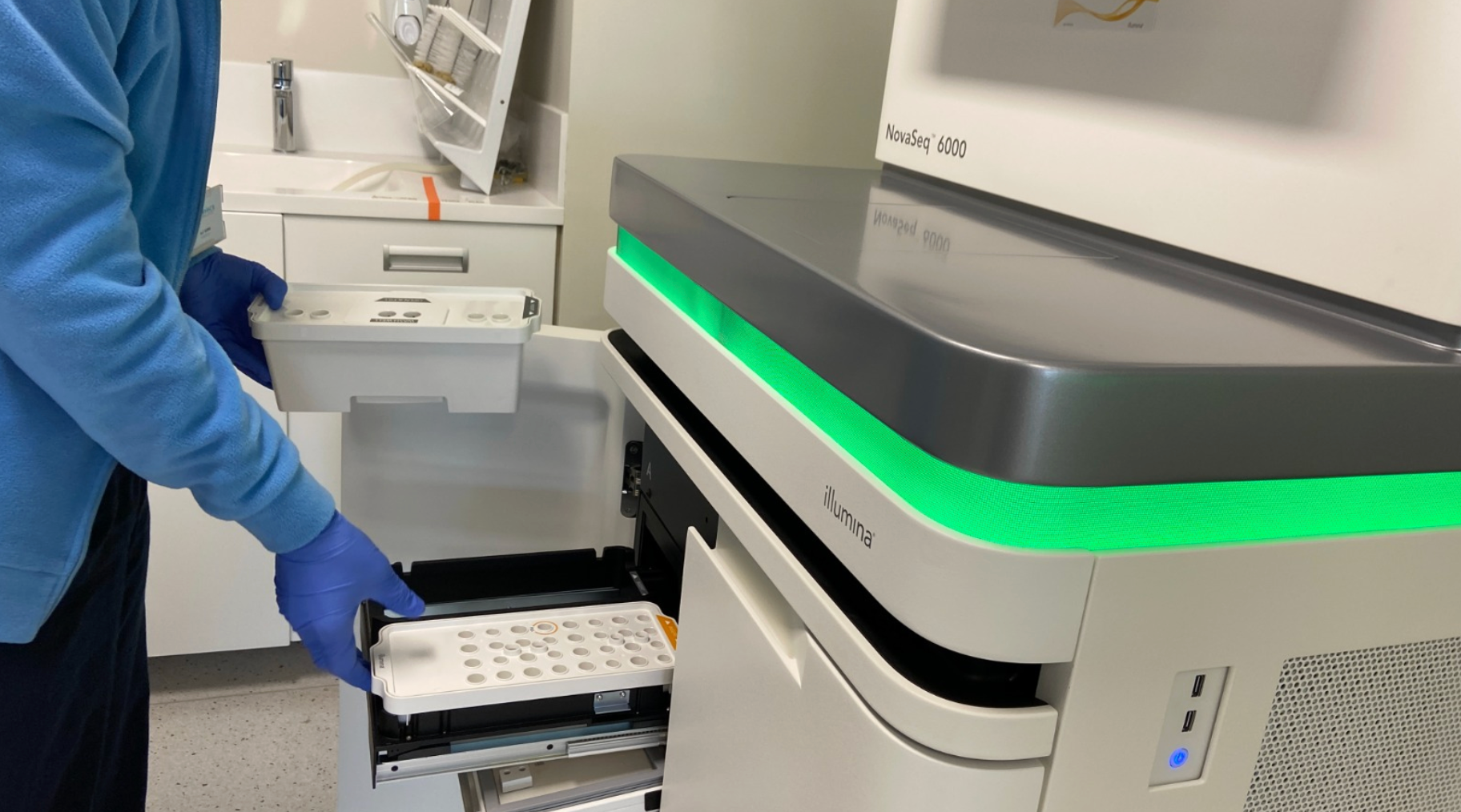 Laboratory technician using an Illumina machine for genetic testing