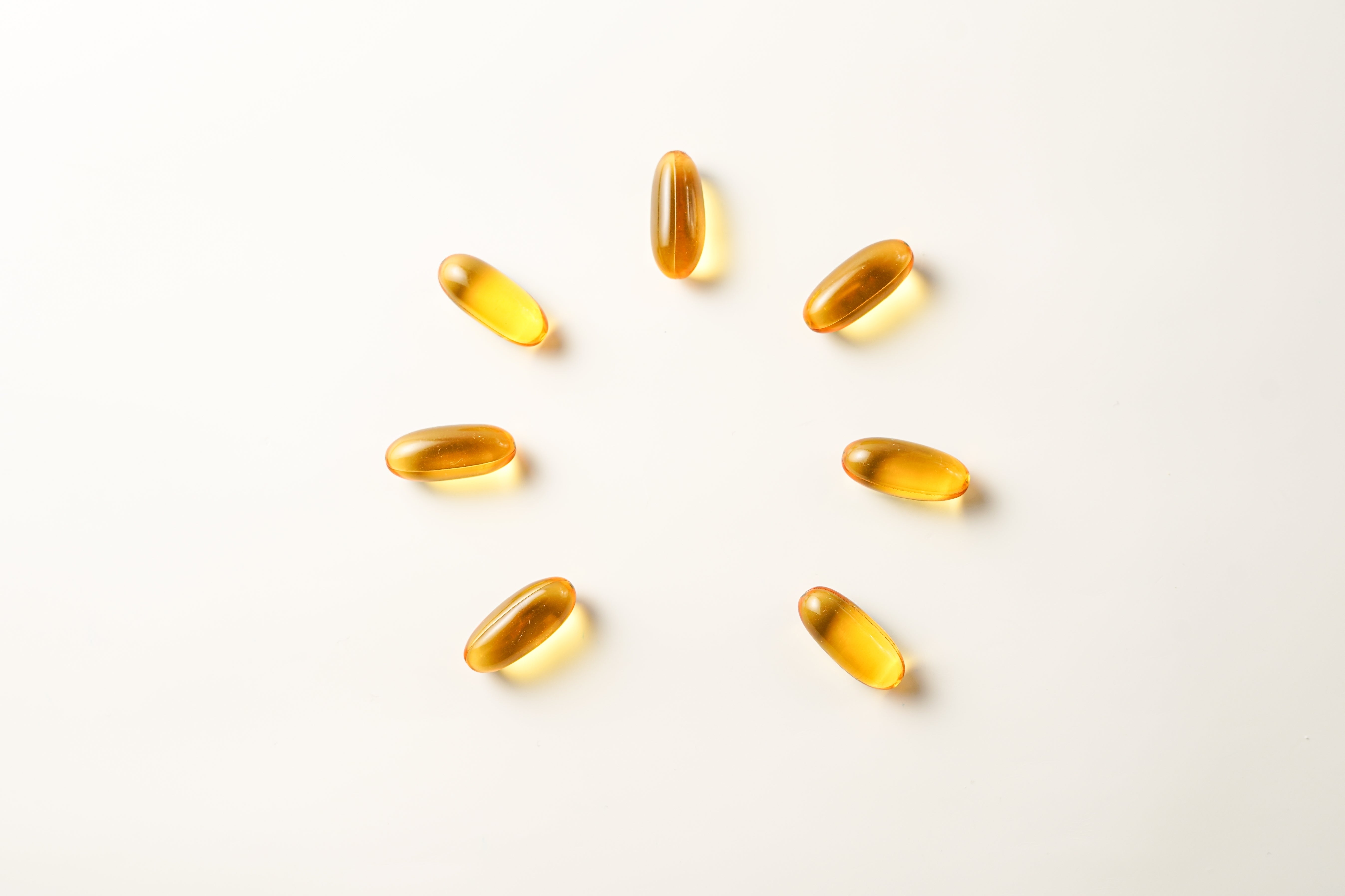 Yellow capsules on a white background