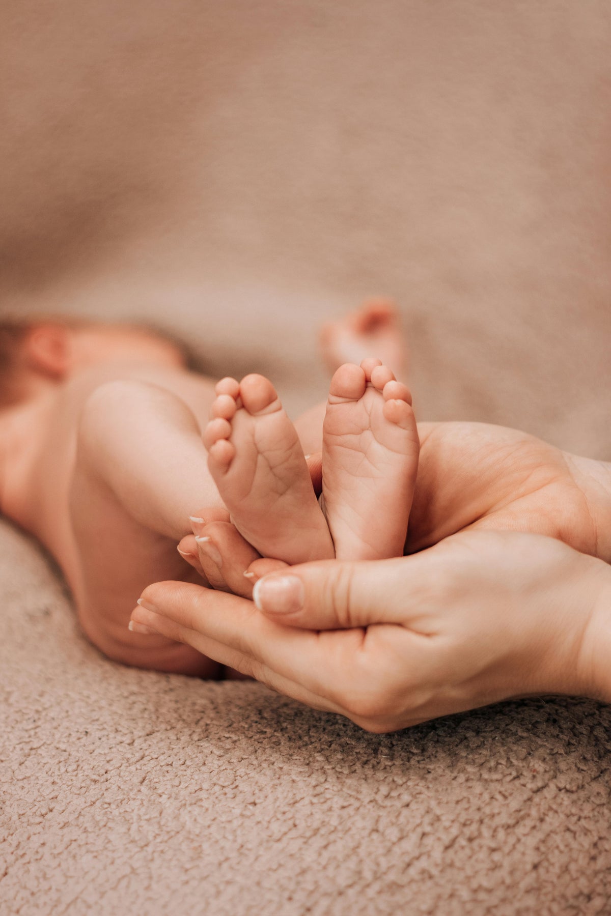 A parent holding an newborn's feet, representing newborn